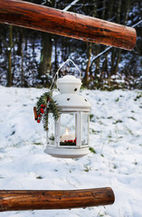 White iron lantern in winter garden.