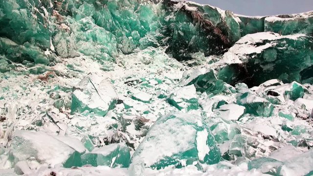 Glacier of beautiful unique turquoise color on background of snow in Arctic. Amazing ice desert landscape. Silence quiet of wilderness North Pole Way to Pyramid on Spitsbergen Svalbard in Norway.