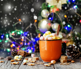 a cup of Christmas hot cocoa with marshmallow New Year's lights and decorations, selective focus