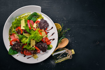 Beef Salad and Fresh Vegetables. On a wooden surface. Top view. Free space for your text.