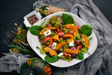 Pumpkin Salad. Healthy food. On a wooden surface. Top view. Free space for your text.