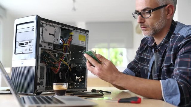 Technician repairing computer hardware