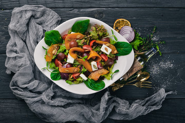Pumpkin Salad. Healthy food. On a wooden surface. Top view. Free space for your text.