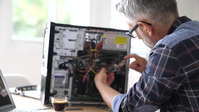 Technician repairing computer hardware