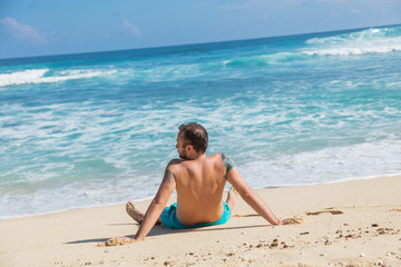 Fototapeta na wymiar Man enjoying on empty tropical exotic beach.