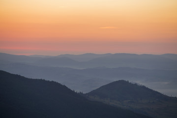 Sunrise against the background of the Carpathian mountains in the summer. Ukraine