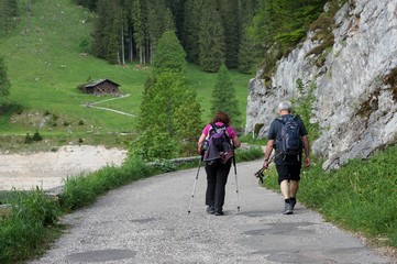 Man and woman hiking on mountain path