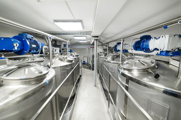 A long gangway between two rows of cisterns. Storage of food liquids.