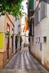 Fototapeta na wymiar The national flag of Spain hang on the balcony
