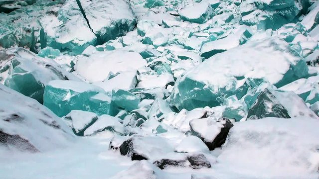 Glacier of beautiful unique turquoise color on background of snow in Arctic. Amazing ice desert landscape. Silence quiet of wilderness North Pole Way to Pyramid on Spitsbergen Svalbard in Norway.