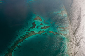 Tropical islands and atolls in Maldives in Indian Ocean from aerial view. Piece of paradise on the Earth. Good choice for vacation. Beautiful top view for wallpaper.