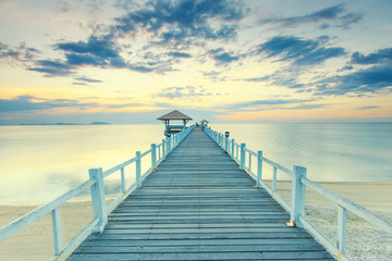 Obraz premium Old wood bridge pier against beautiful sunset sky use for natural background ,backdrop and multipurpose sea scene