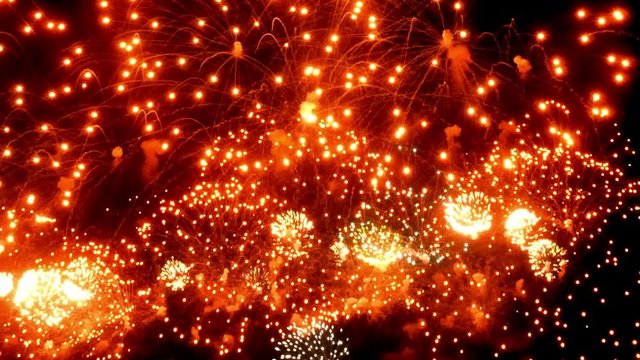 Firework display at night on black background. Bright glaring red green yellow explosions. Amazingly beautiful. Salute for new year Christmas and other holidays. Macro video closeup footage 30p.