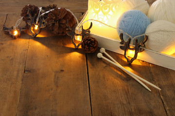 warm and cozy yarn balls of wool on wooden table.