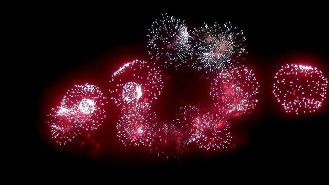 Firework display at night on black background. Bright red green yellow explosions. Amazingly beautiful. Salute for new year, Christmas and other holidays. Macro video closeup footage 50p.