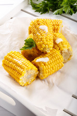 Boiled sweet corn cob with butter and salt