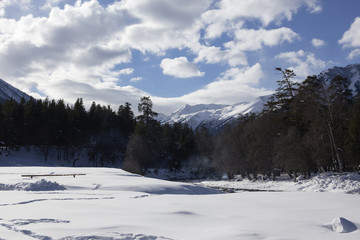 Fototapeta na wymiar Winter panorama of the mountain with valleys and forest.