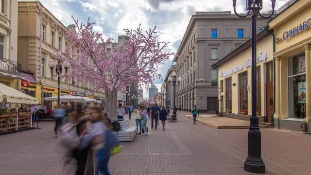 Locals and tourists walking on famous pedestrian Arbat Street timelapse hyperlapse in Moscow, Russia. People sitting on a bench