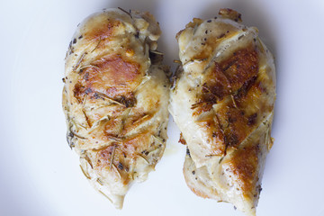 Chicken fillet laying around on a white background