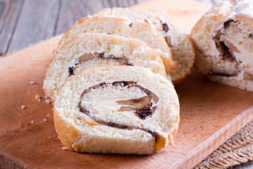 Slices of sweet cream roll on a cutting board
