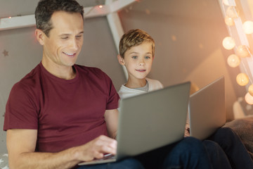 Attentive kid looking at screen of computer