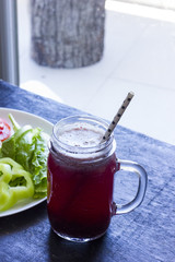 A fresh meal of chicken fillet with vegetables and tasty juice on a dark wooden background
