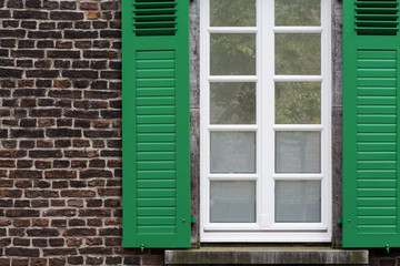 Obraz na płótnie Canvas Window with Green Open Wooden Shutters
