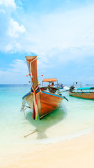 Longtale boat on the white beach at Phuket, Thailand. Phuket is a popular destination famous for its beaches.