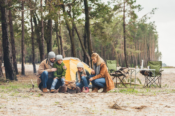 family making campfire