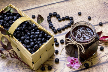 Homemade blueberry jam; Basket full with fress blueberries; Healthy heart symbol