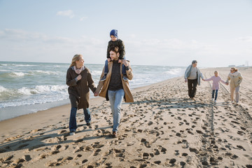 family walking together on seashore