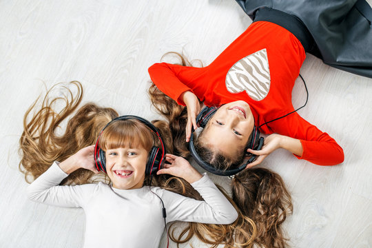 Children listen to music on headphones. Concept music, radio, dance, life stroke, rest.