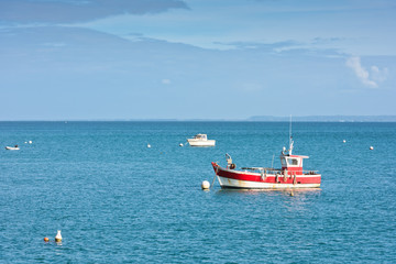 Fototapeta premium Bright blue sea and fisherman boats