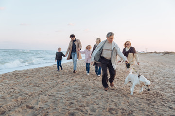 multigenerational family walking with dog