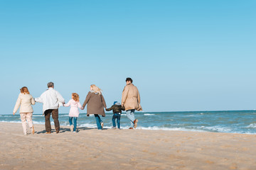 Fototapeta na wymiar family walking at seashore