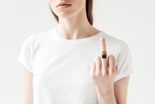 middle finger with painted rainbow flag