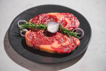 Raw fresh beef on white stone background, top view