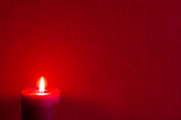 Christmas red textile background with candle