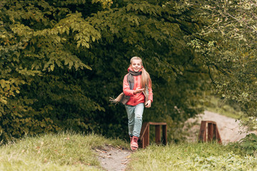 child running in autumn park