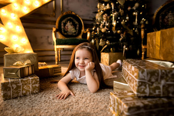 Fototapeta na wymiar On Christmas night a little girl waiting for Santa Claus.
