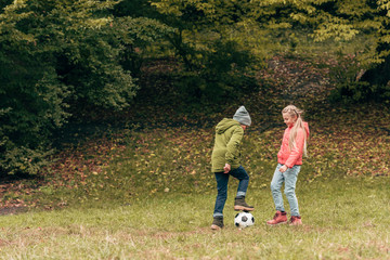 kids playing soccer in park
