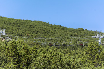 Fototapeta na wymiar chair lift in a pine mountain