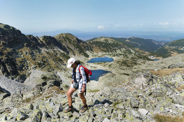 Happy hiker woman on the top of a mountain with stunning view .Musala peak in RIla mountain,Bulgaria