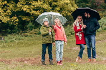 parents and kids with umbrellas