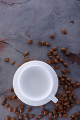 Empy cup and coffee beans on stone kitchen table