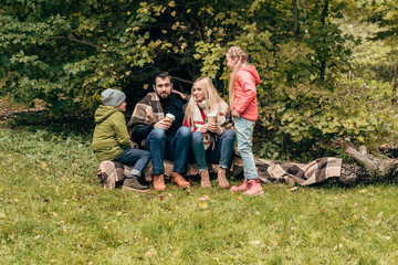 family with coffee to go in park