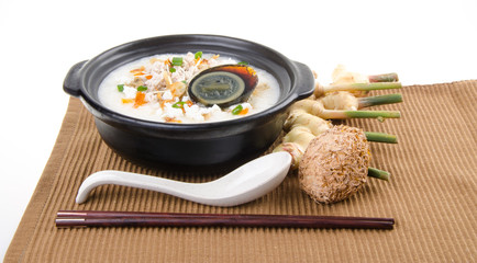 Traditional chinese century egg & pork porridge rice gruel served in claypot