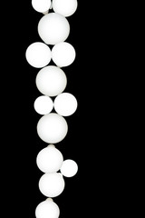 Isolated picture of white round lamps on the black wall.