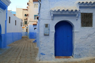 Fototapeta na wymiar Typical blue doors in the streets of Chauen, Morocco