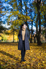 young woman walking in autumn park